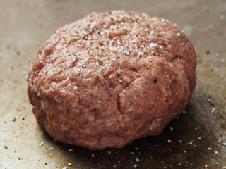 rustic uncooked seasoned hamburger patty