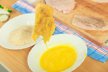 Preparing meal of breaded chicken cutlets
