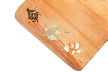 Spices on wooden cutting board over white background