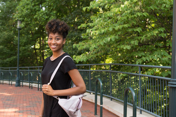 Young african american college student walking on campus