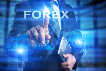 Businessman is pressing on the virtual screen and selecting Forex.