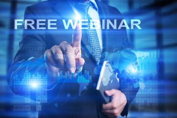 Businessman is pressing on the virtual screen and selecting Free webinar.