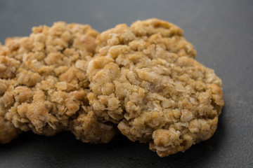 Extreme closeup of oatmeal cookies on black counter