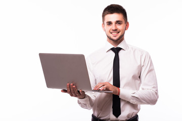 Handsome young businessman standing and using laptop over white background