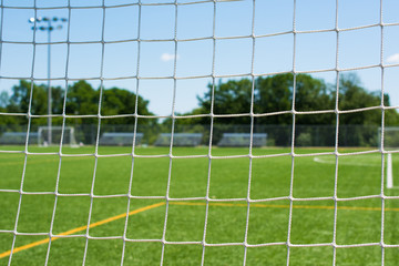 Soccer net on sports field closeup © billlivingstone