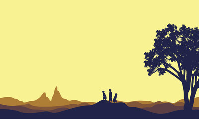 Fototapeta premium Meerkat at afternoon landscape silhouette