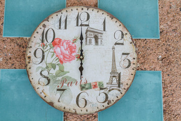 Vintage clock show 6 am or pm on wall background.