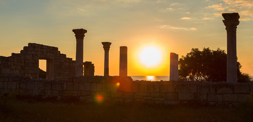 Fototapeta na wymiar Ancient Greek basilica and marble columns in Chersonesus Taurica on the sunset background.