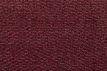 Dark red background from textile material. Fabric with natural texture.