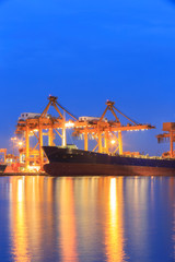 Fototapeta na wymiar Shipyard port terminal evening twilight. Import or Export cargo concept background.