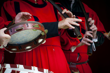 Closeup of the hands of a medieval court musicians playing the drums and the flute