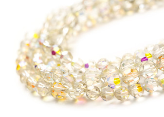 Shiny glass necklace on white background