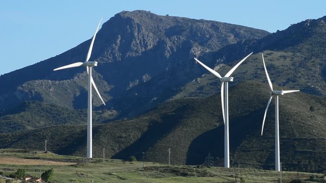 Wind turbines energy tower moving at mountains