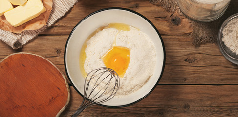 Flour in a bowl with egg yolk