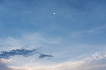 Blue sky and white clouds and moon at dusk