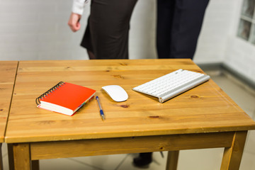 Office workplace with notebook, keyword and computer mouse on wood table