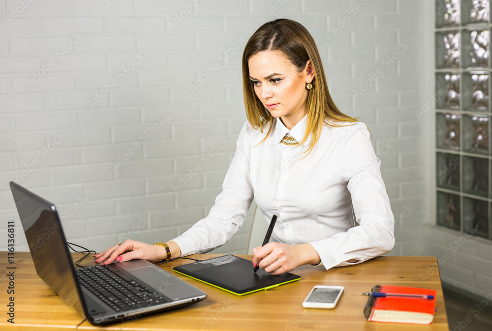Aufkleber graphic designer using digital tablet and computer in the office
