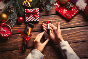 female hands wrapping lipstick