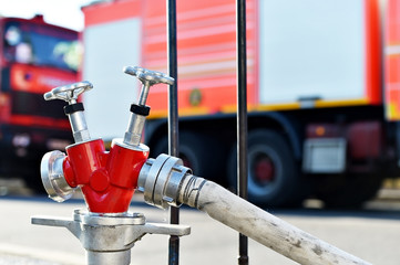 Hydrant with firefighter cars in background