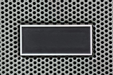 Metal plate label on metal steel grid with repetitive rows of pu