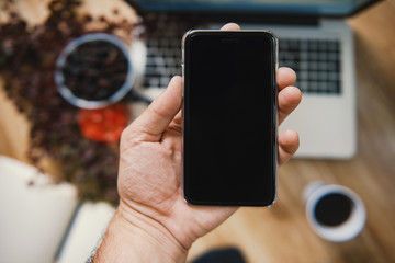 Creative workspace with beautiful flowers and mobile technology.