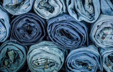 Fototapeta na wymiar bunch of twisted jeans, close-up, fashionable clothes