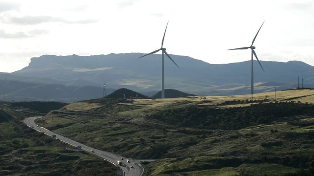 Wind turbines energy renewables towers moving  at sunset