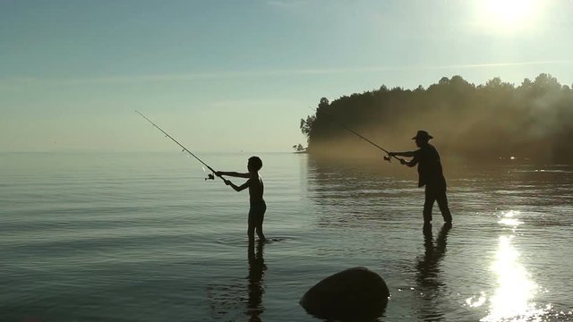 Father and son fishing on the lake.
