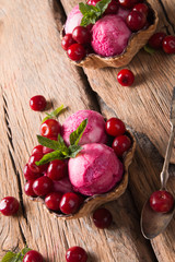 Ice Cream sour cherry, summer sundae with fresh fruits on wooden background. 