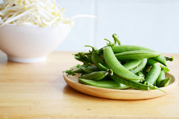 peas and green nut on black background

