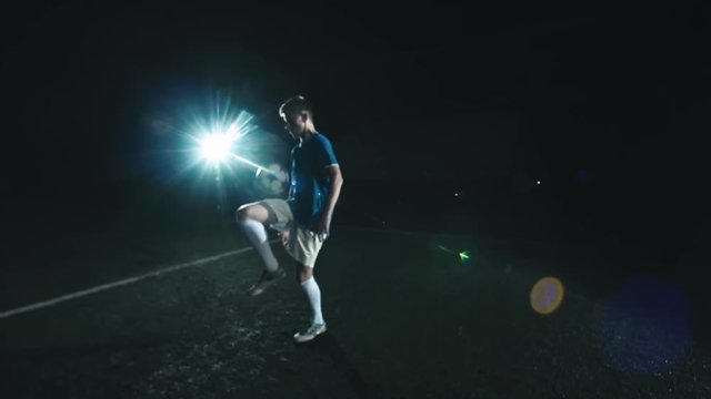 Professional soccer player juggling a ball with the feet