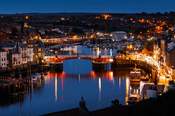 WHITBY, ENGLAND - JULY 16: The swing bridge within Whitby harbour, at night. In Whitby, North Yorkshire, England. On 16th July 2016.