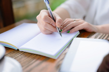 A young woman is writing .