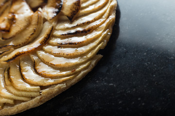 Apple tart background. Traditional french sweet dessert. Delicious, appetizing, homemade pie with slices of fresh fruits. Copy space, closeup
