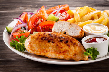 Fried chicken fillet, chips and vegetable salad 