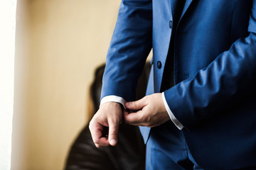 Businessman wears a jacket. Sharp dressed fashionist wearing jac