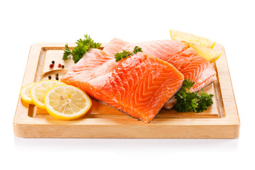 Fresh raw salmon steaks on cutting board 