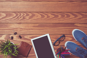 Digital tablet with blank screen with men accessories on wooden table