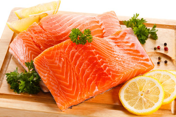 Fresh raw salmon steaks on cutting board 