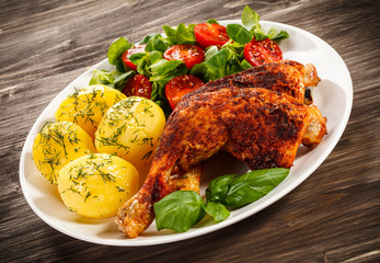 Roast chicken legs with boiled potatoes and vegetables 