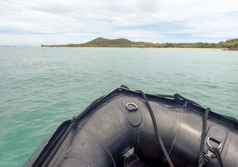 Black dingy boat in the sea