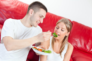 Young couple is having breakfast at their home