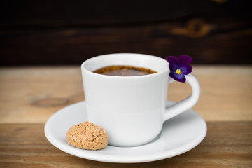 Cup of espresso with biscotti on wooden table