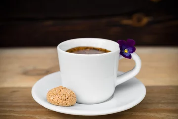 Fotobehang Cup of espresso with biscotti on wooden table © webstoodio