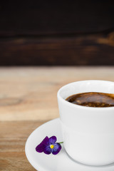 Espresso coffee in white cup on wooden table