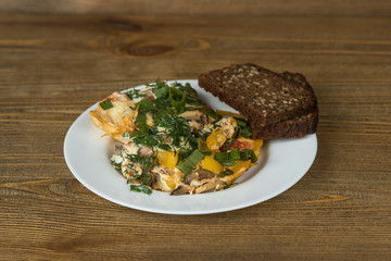 scrambled eggs on a plate on wooden table