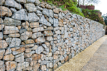 Wire Gabion Rock Fence. Metal Cage filled with rocks.