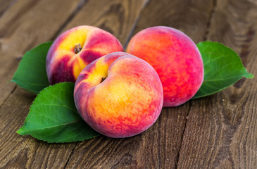 fresh peaches on wood background