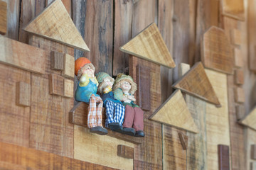 happy Ceramic dolls sitting on wood wall for interiors home