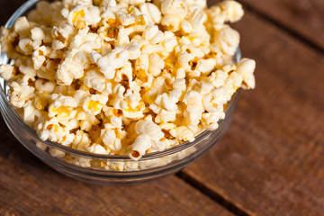 Salt popcorn on the wooden table